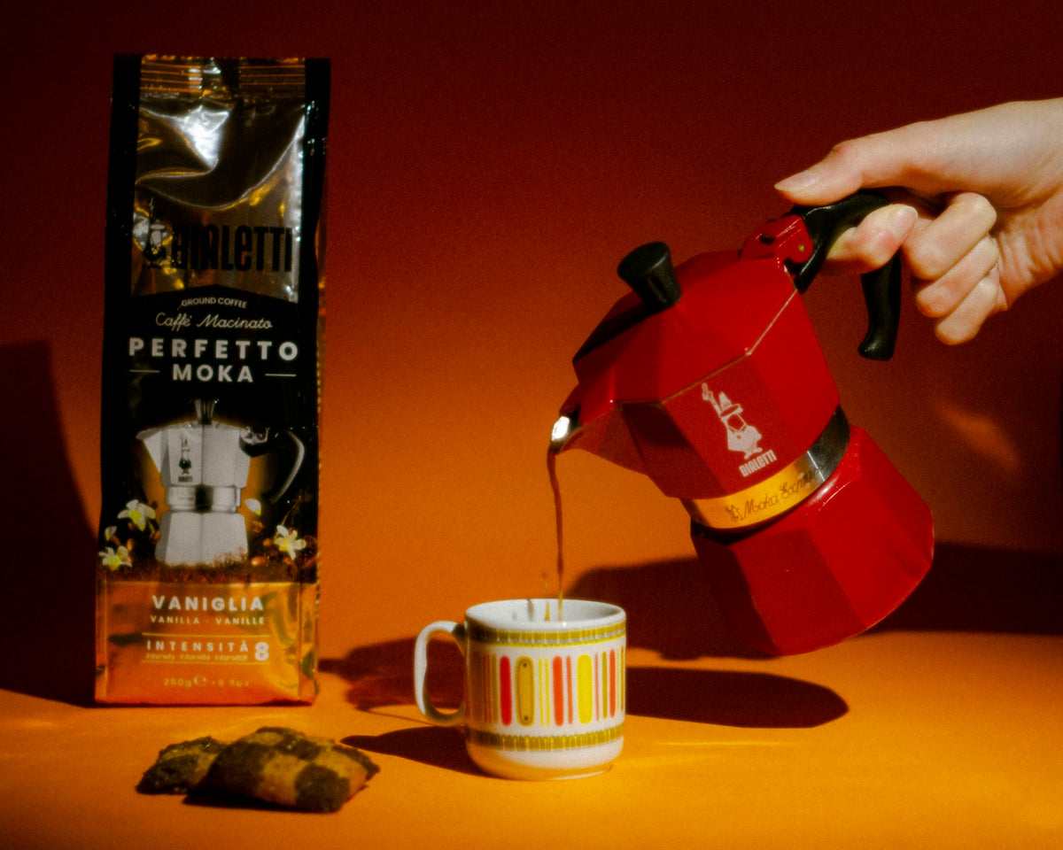 a person is pouring coffee into a cup
